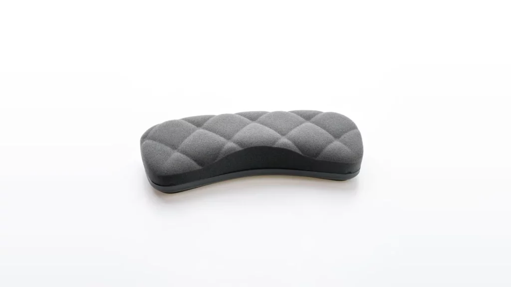 Grey quilted keyboard wrist rest on a white surface